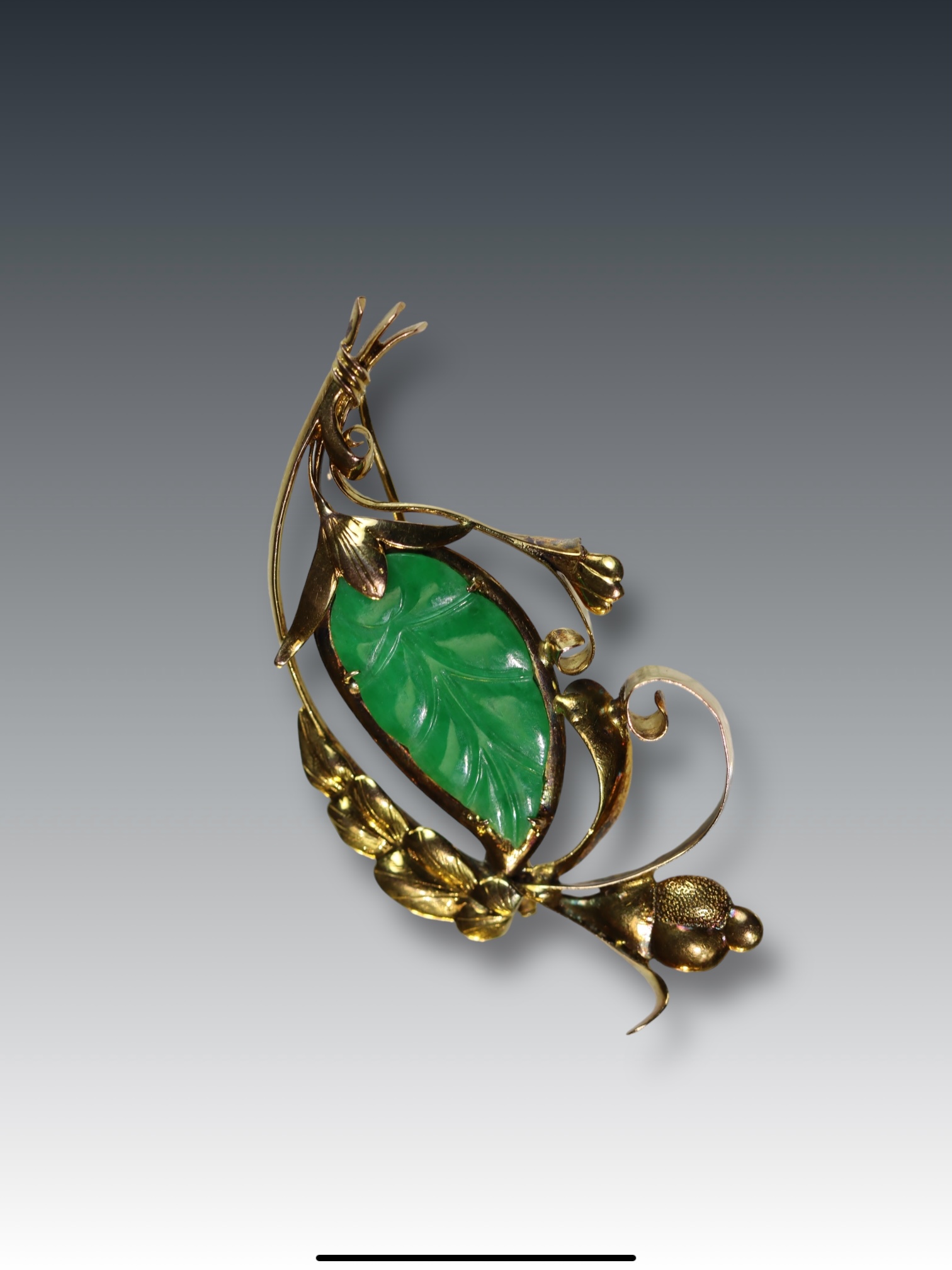 A 1940's Jadeite Brooch the strong apple green coloured jadeite carved as a leaf, with yellow