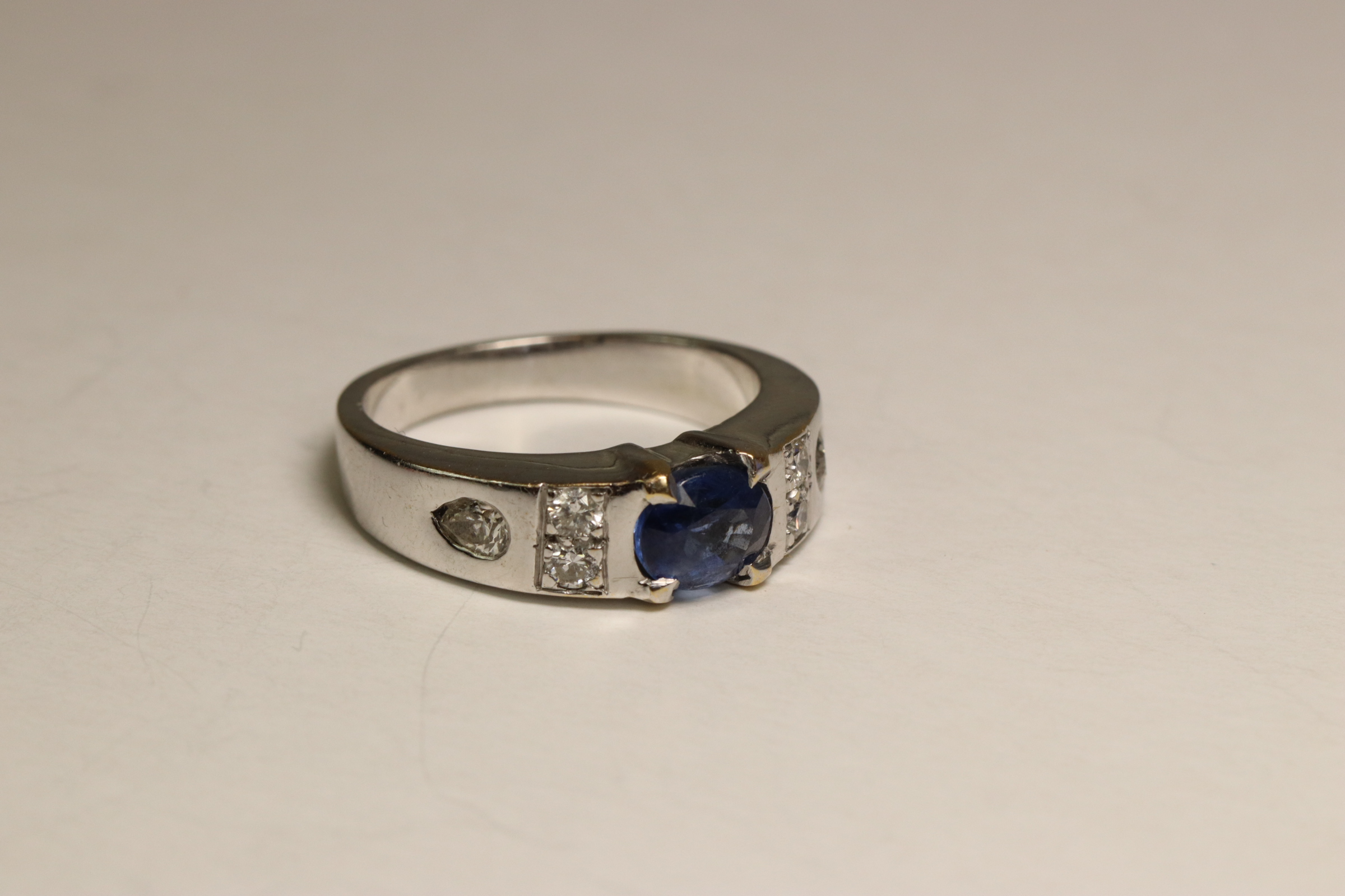 A Sapphire and Diamond Dress Ring, Circa 1990 A Sapphire and Diamond Dress Ring, Circa 1990 The oval