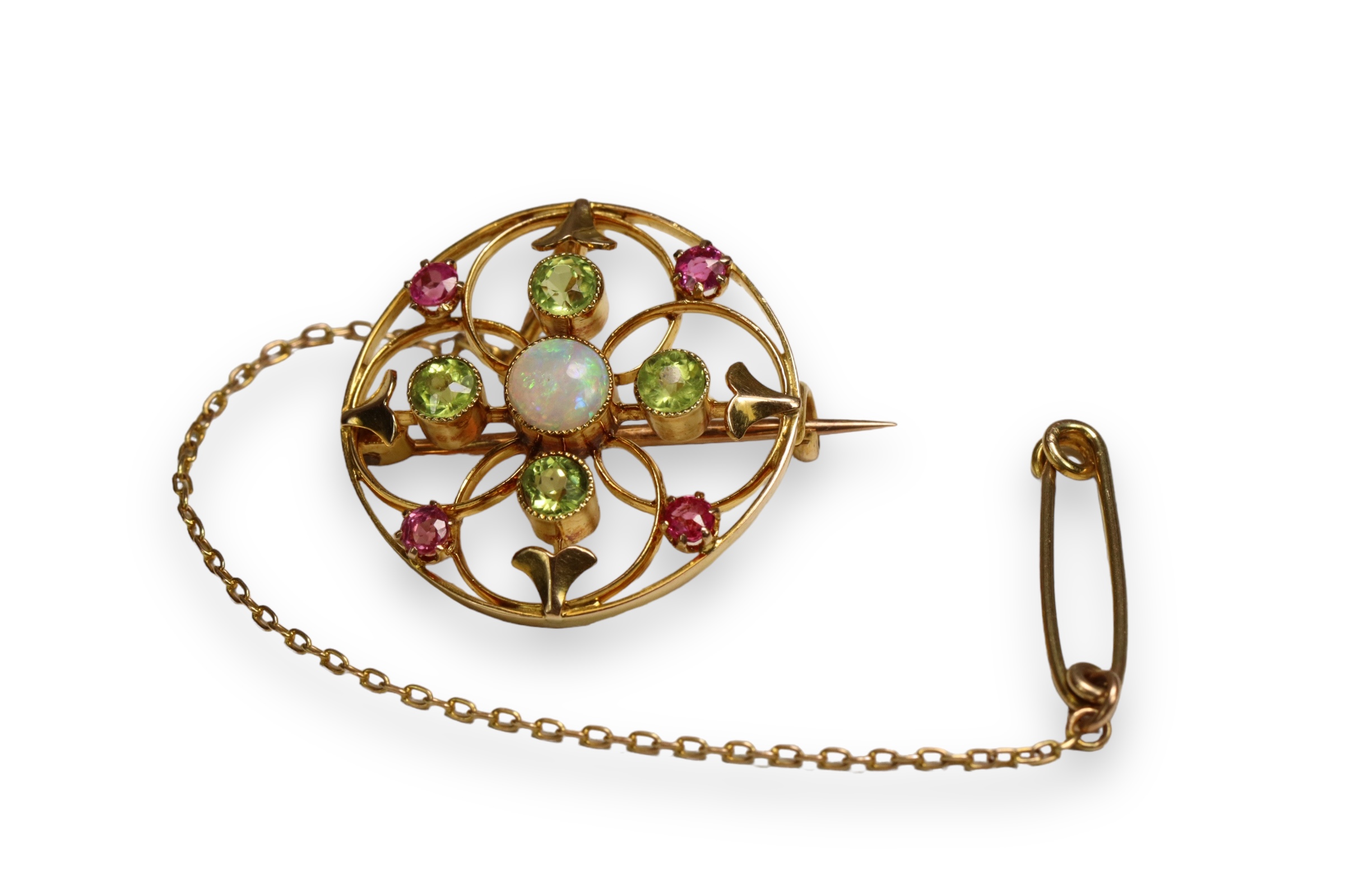 An Antique Opal, Peridot and Pink Stone Target Brooch, circa 1910 Millegraine set central opal,