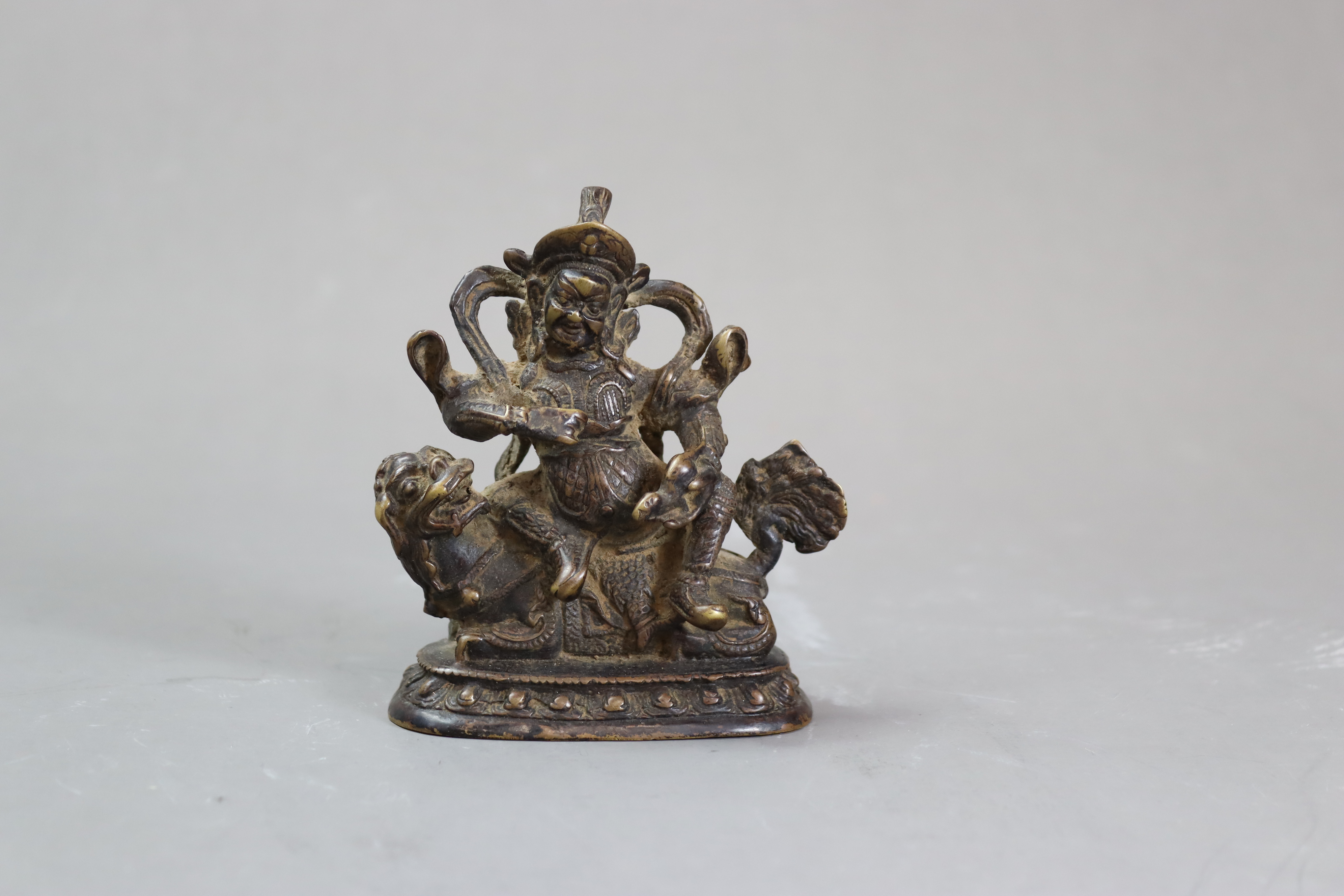 A Bronze God of Fortune, 19/20th centurythe fierce bearded deity clutching his mongoose, with dark - Image 2 of 8