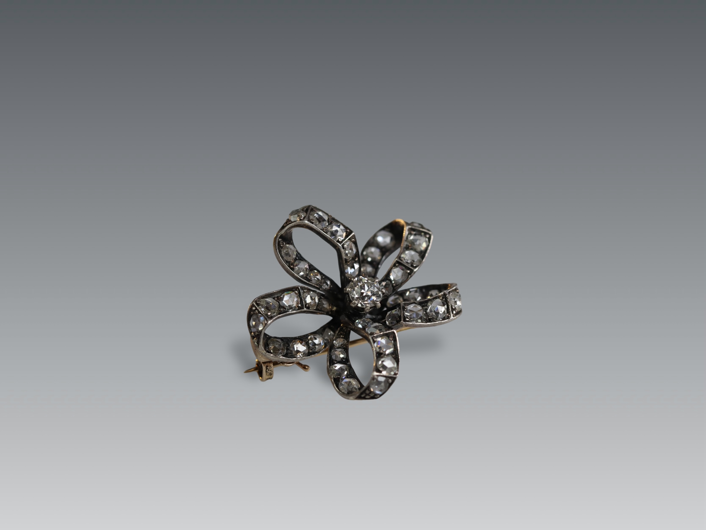 An Antique Diamond and a rose-cut Diamond Stylised Bow Brooch, circa 1890, centrally set with a