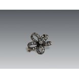 An Antique Diamond and a rose-cut Diamond Stylised Bow Brooch, circa 1890, centrally set with a