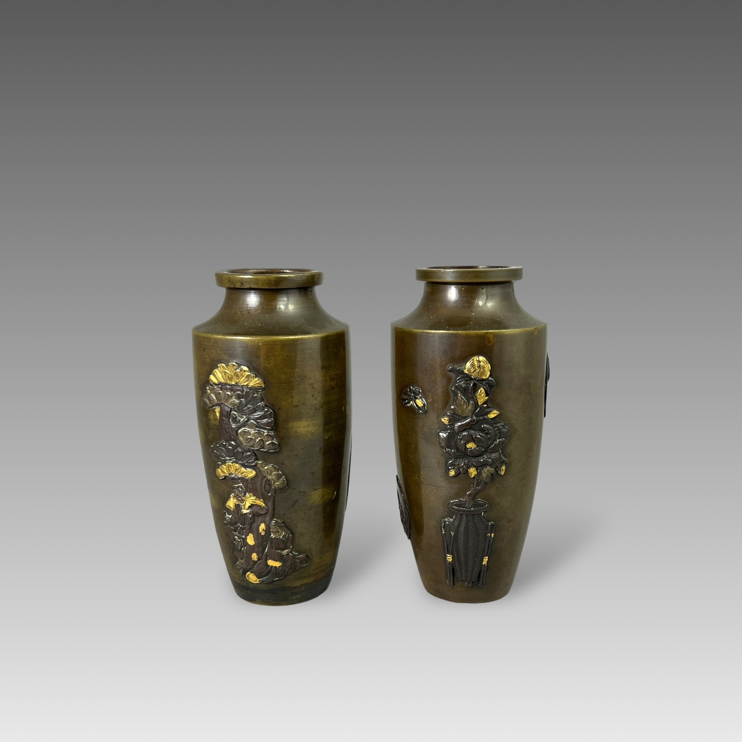 A small Pair of Japanese mixed metal Vases, Meiji periodthe sides decorated in low relief in gilt,