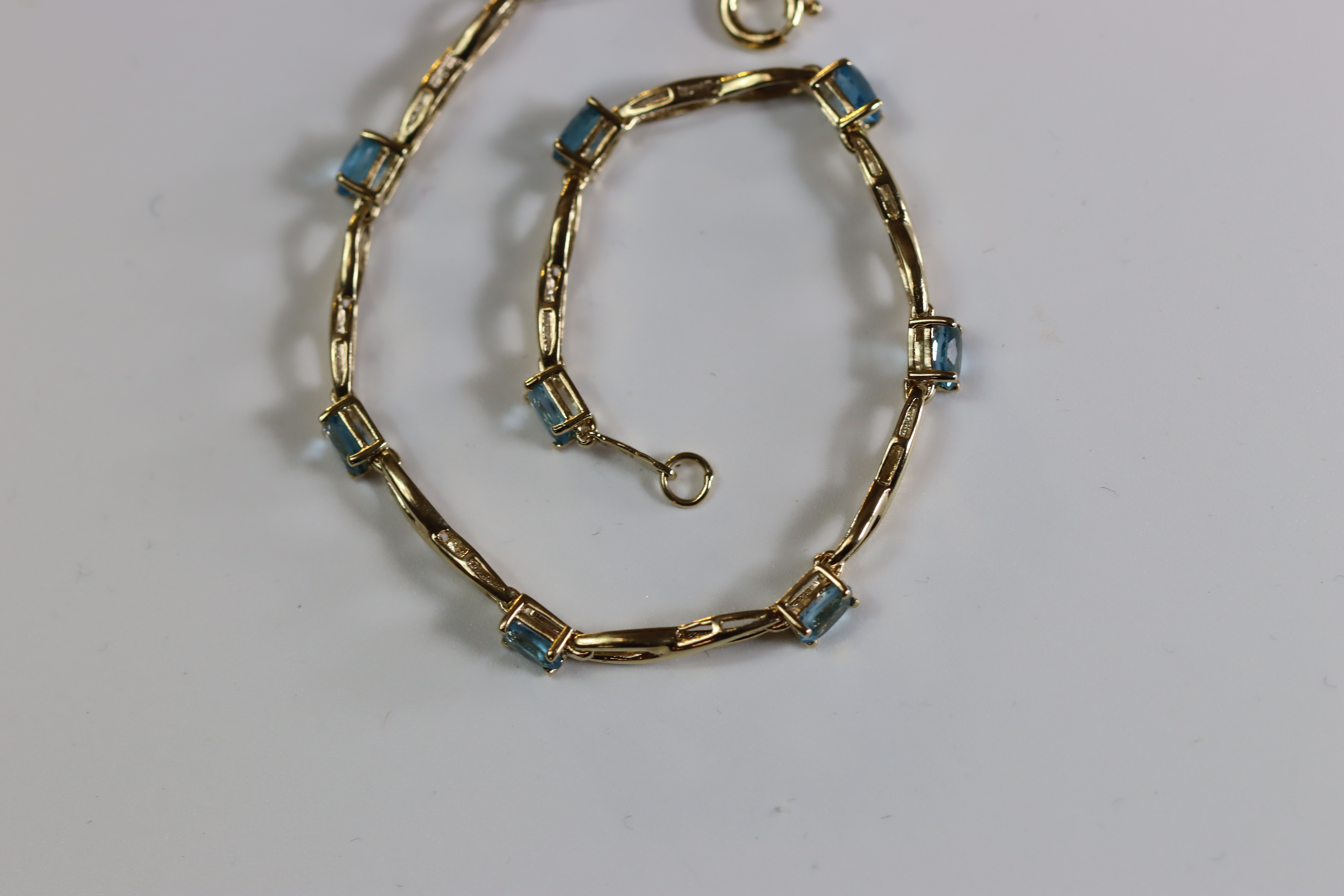 A Blue Topaz and Yellow Metal Line Bracelet A Blue Topaz and Yellow Metal Line Bracelet, set with - Image 6 of 8