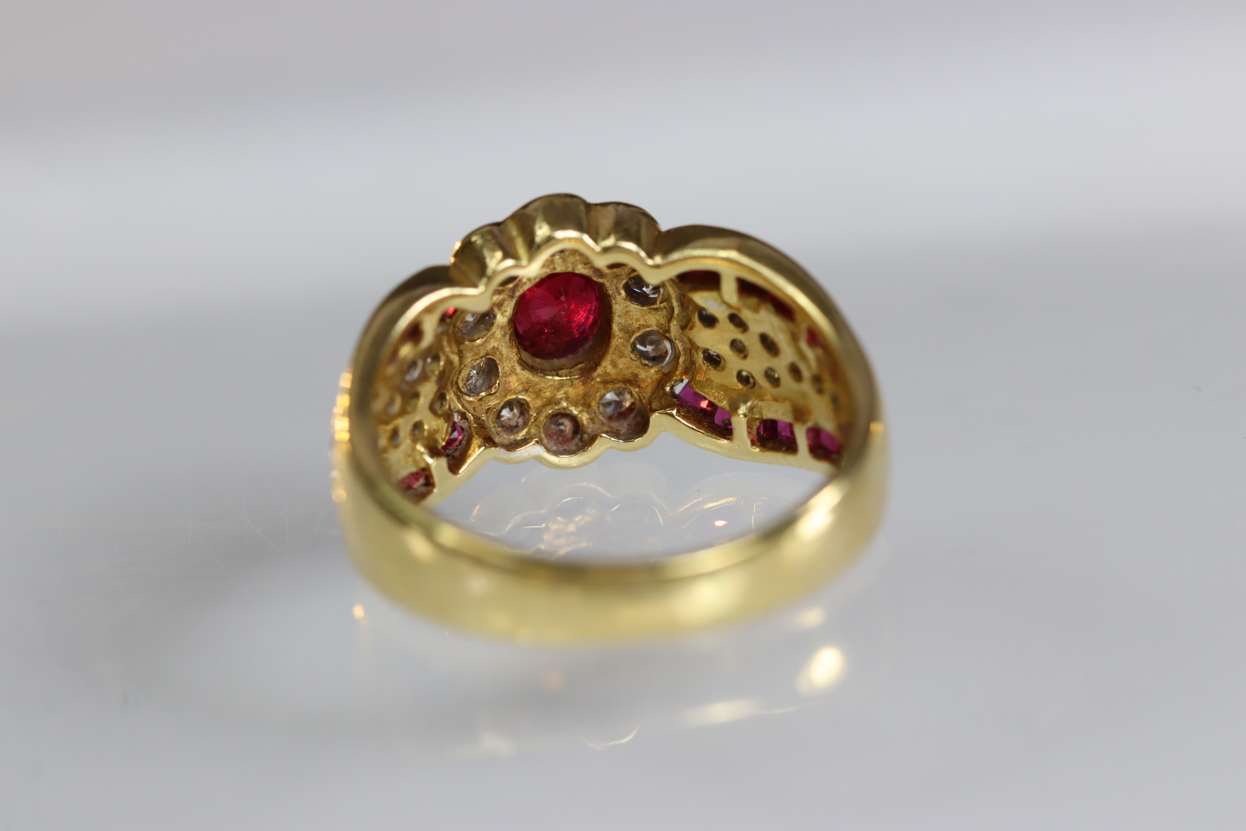 A contemporary 18 carat Yellow Gold, Ruby and Diamond Dress Ring,the oval shaped ruby central - Image 12 of 14