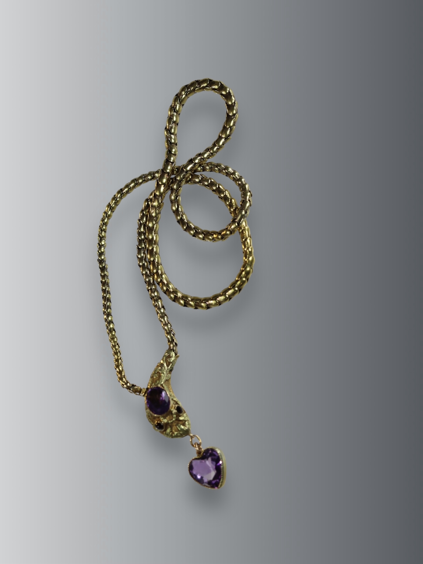 An Antique Gold and Amethyst Snake Necklace, circa1860,the head set with an oval shaped millgrain
