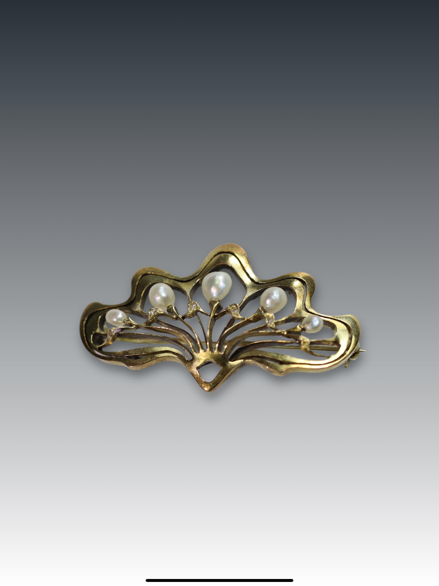 A Natural Pearl and Yellow Gold Brooch, circa 1910 of Art Nouveau style set with five graduated