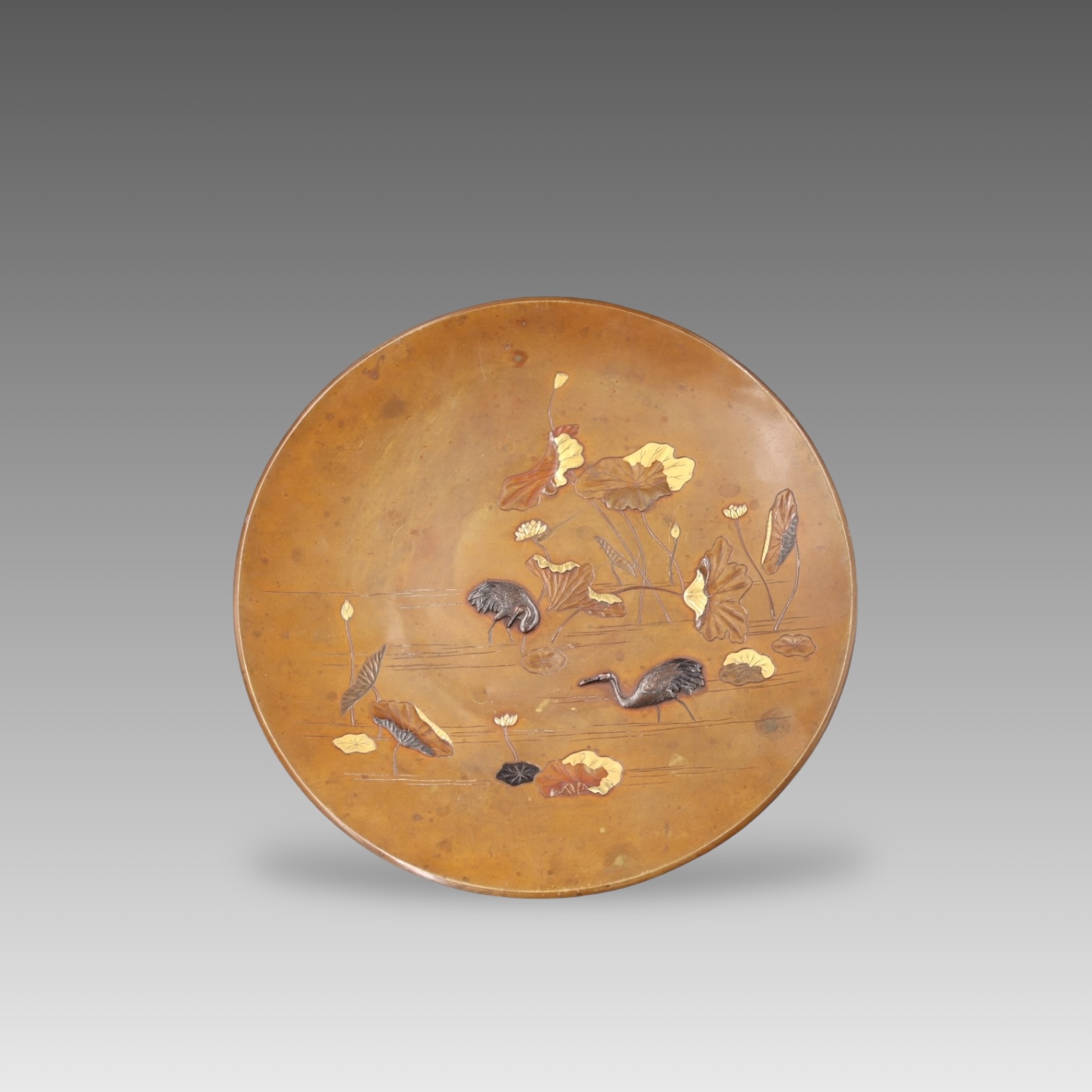 A Japanese Goldwork Appreciation Plate, Meiji period.with a lotus pond, with two cranes playing in