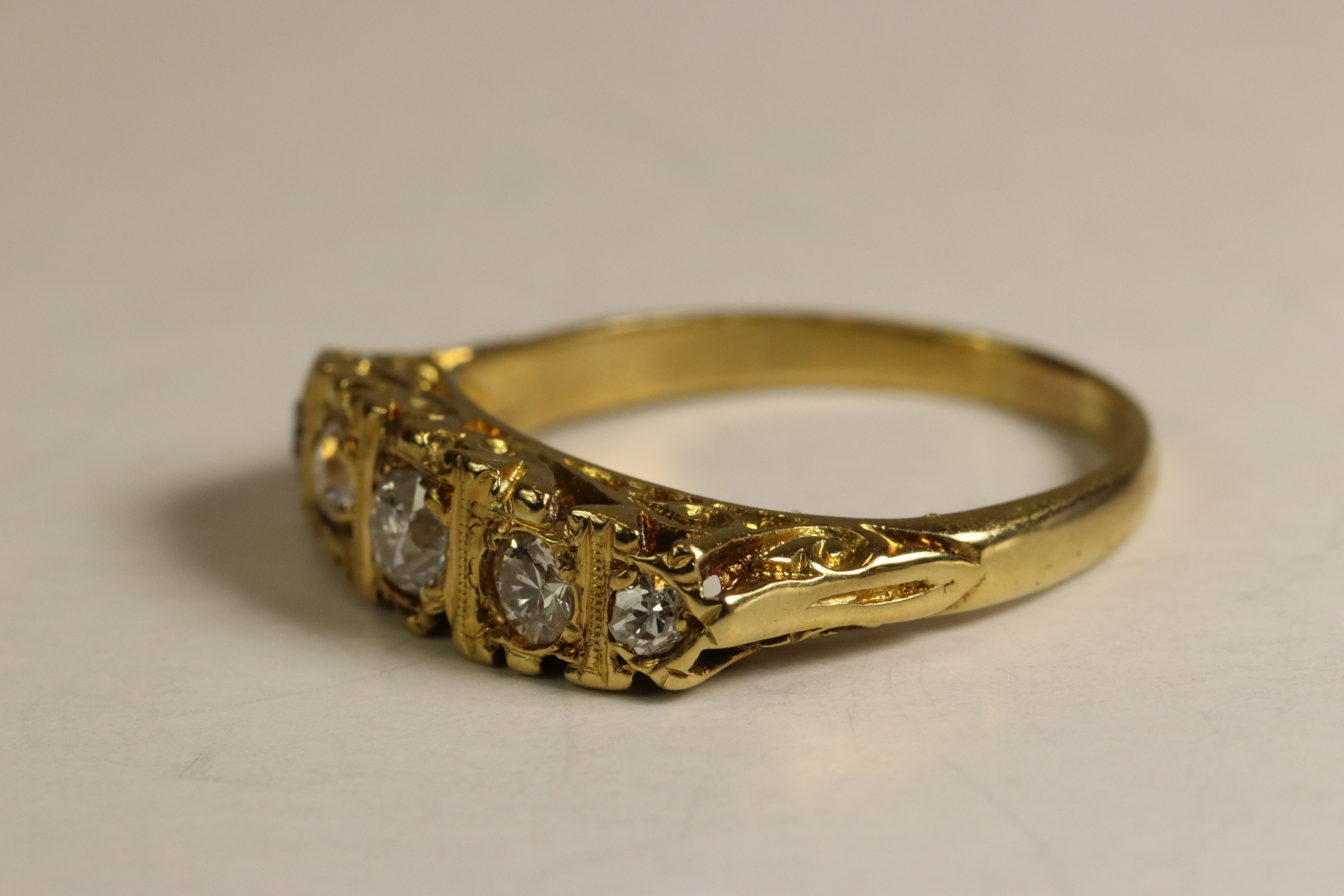 A Diamond Five Stone Ring, The graduated old brilliant cut diamonds mounted in a carved 18 ct - Image 3 of 6