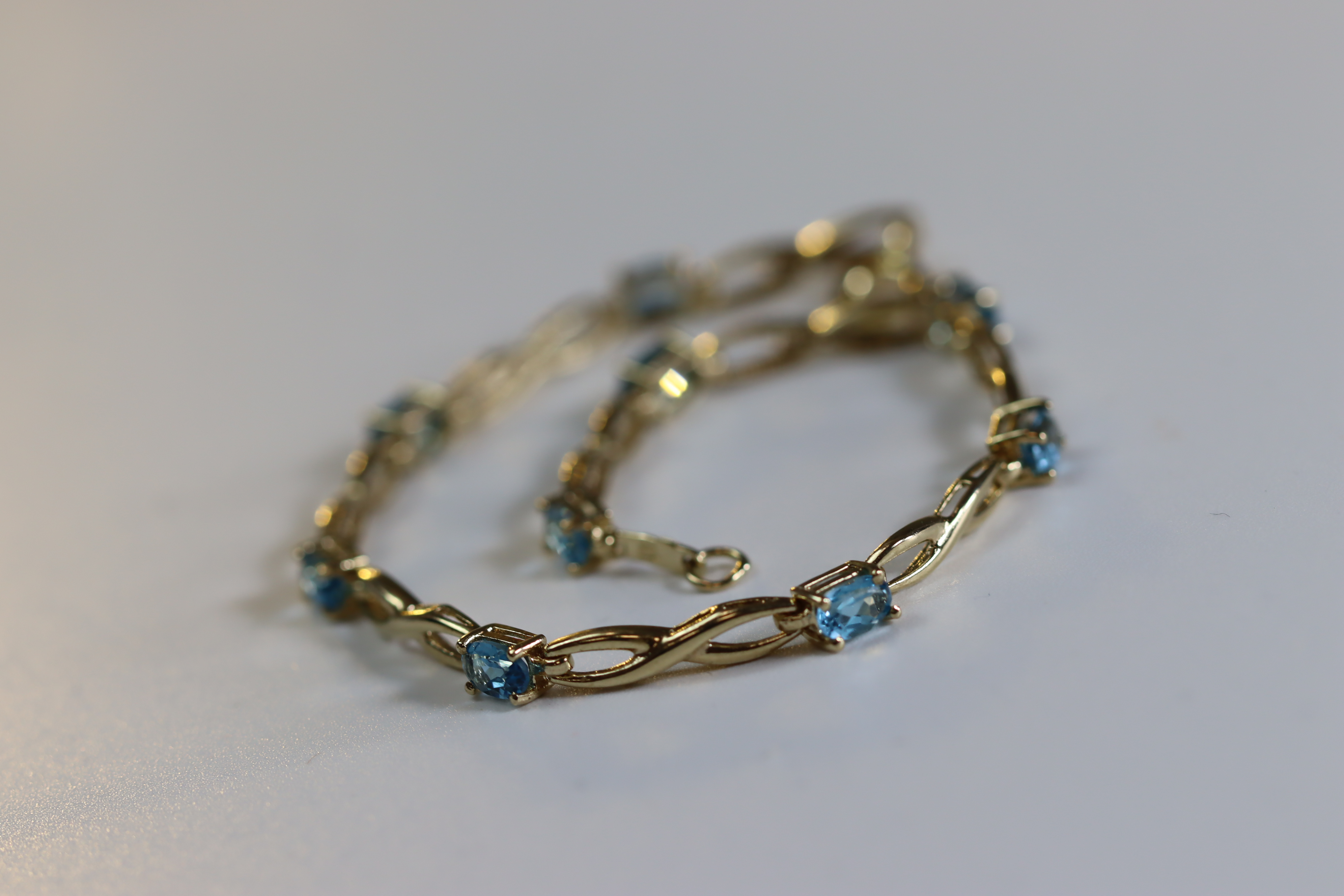 A Blue Topaz and Yellow Metal Line Bracelet A Blue Topaz and Yellow Metal Line Bracelet, set with - Image 7 of 8