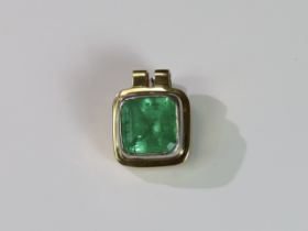 A Large Emerald Single Stone Pendant, the cushion shaped single stone emerald weighing approx. 12