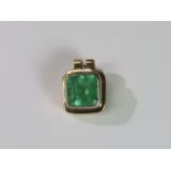 A Large Emerald Single Stone Pendant, the cushion shaped single stone emerald weighing approx. 12