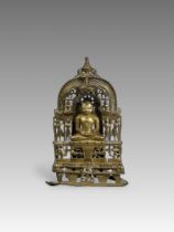 A Bronze Jain shrine. India 15th century.A Jain shrine depicting a Tirthankara with silver inlaid