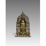 A Bronze Jain shrine. India 15th century.A Jain shrine depicting a Tirthankara with silver inlaid