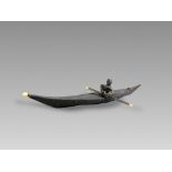 An Inuit Kayak Model. Artic Canada ca. Late 19th Century.A good kayak model and figurine made of