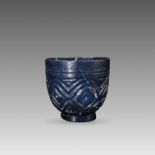 A Sasanian linear-cut blue glass bowl, 11th/12th CenturyA Sasanian linear-cut blue glass bowl,