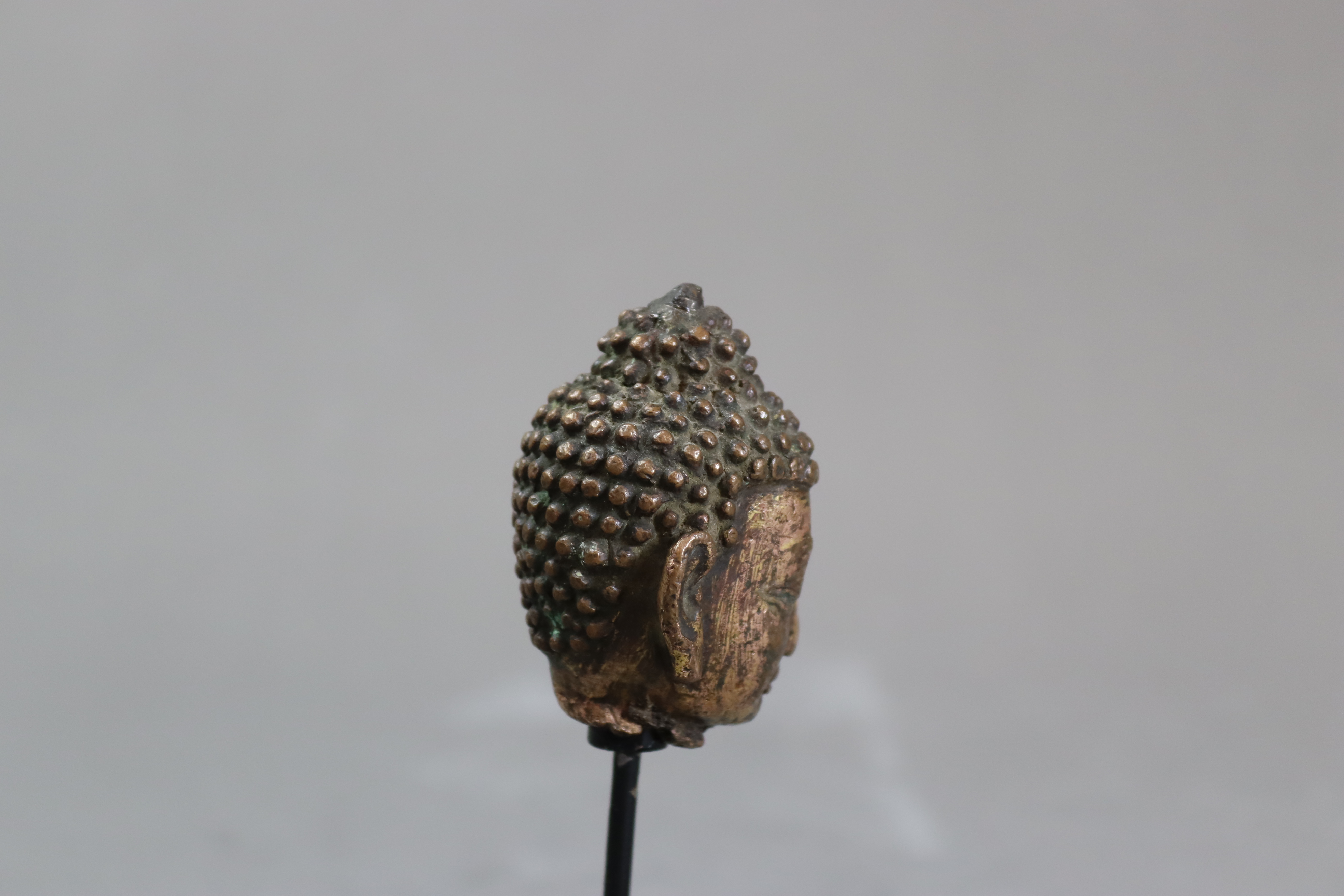 A Gilt Bronze Head of Buddha, 13th centurysensitively modelled with serene downcast gaze, still with - Image 3 of 7