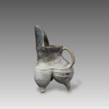 A Black Pottery Tripod Vessel, Neolithic,with spout shaped like a bird head , restoration upper