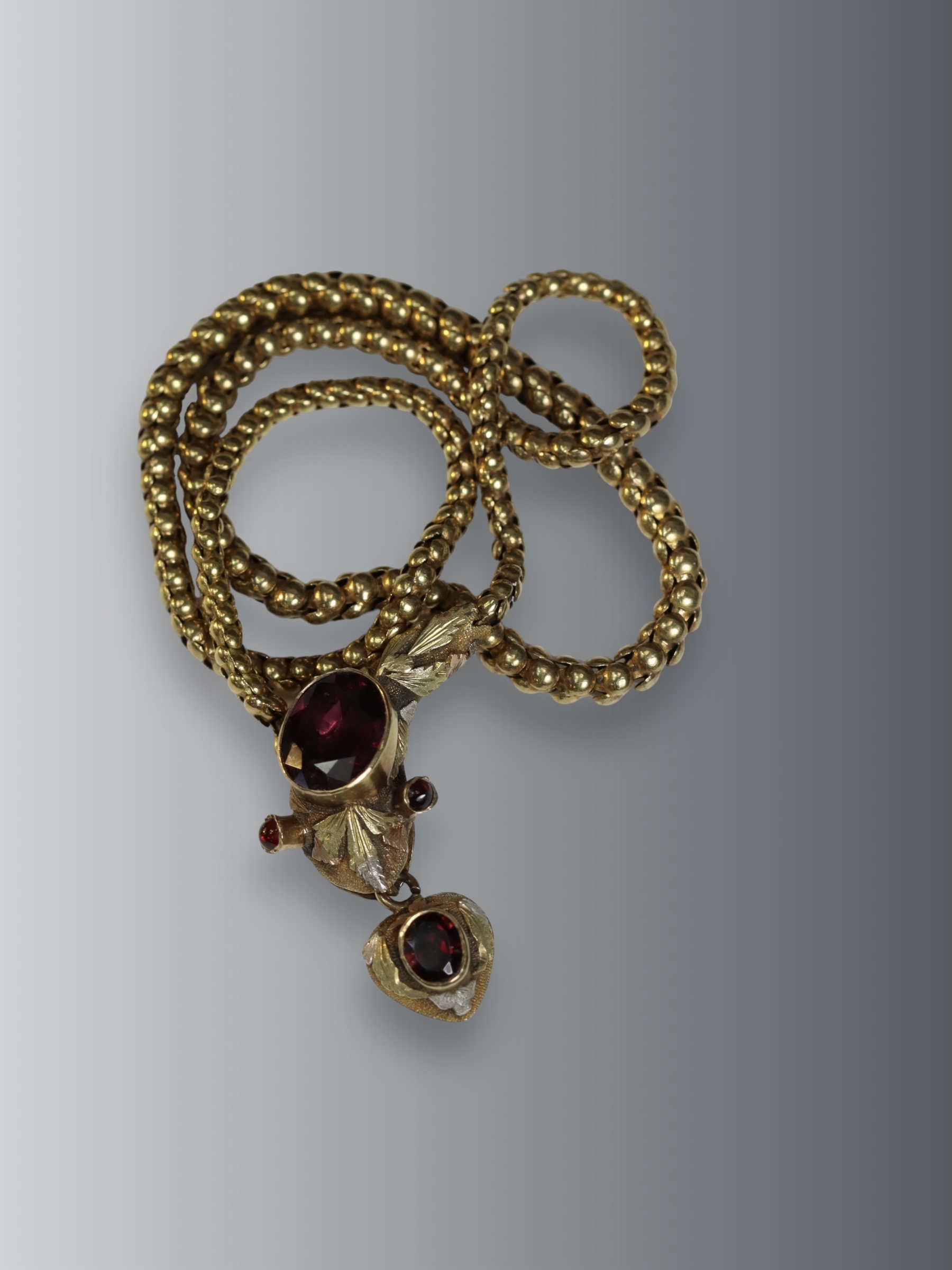 An Antique Cabochon Garnet and Gold Snake Necklace, circa 1860, the head formed from a cabochon