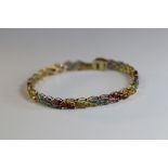 A Multi Gem Set Line Bracelet set throughout with marquise shaped amethyst, blue topaz, peridot,