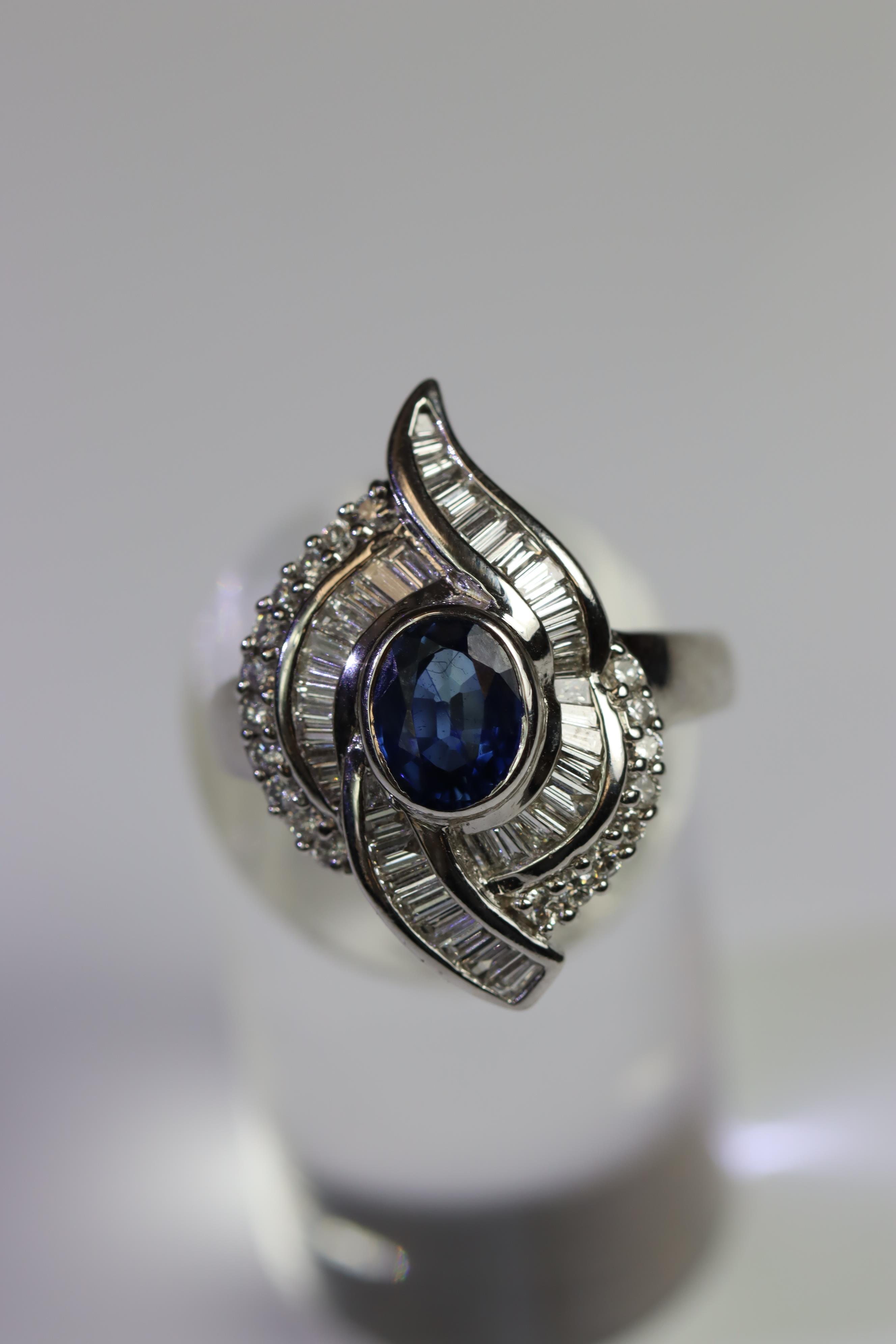 A contemporary Sapphire and Diamond Cluster Ring,the oval shaped central sapphire with rub over - Image 8 of 16