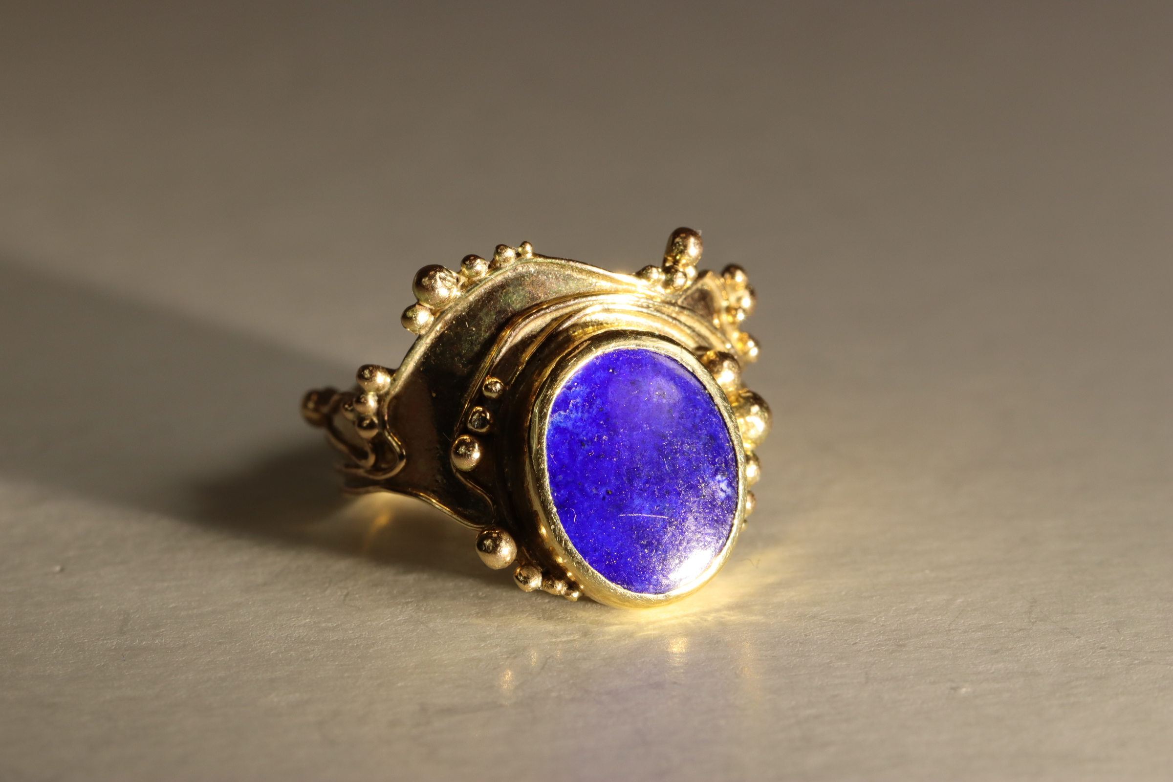 A Lapis Lazuli and 9 ct Yellow Gold Dress Ring, circa 1970. The oval-shaped lapis lazuli stone