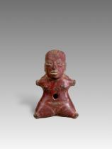 A Tlatilco female figurine. Formative period. Mexico ca. 1200-800 BC.The female seated figure