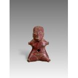 A Tlatilco female figurine. Formative period. Mexico ca. 1200-800 BC.The female seated figure