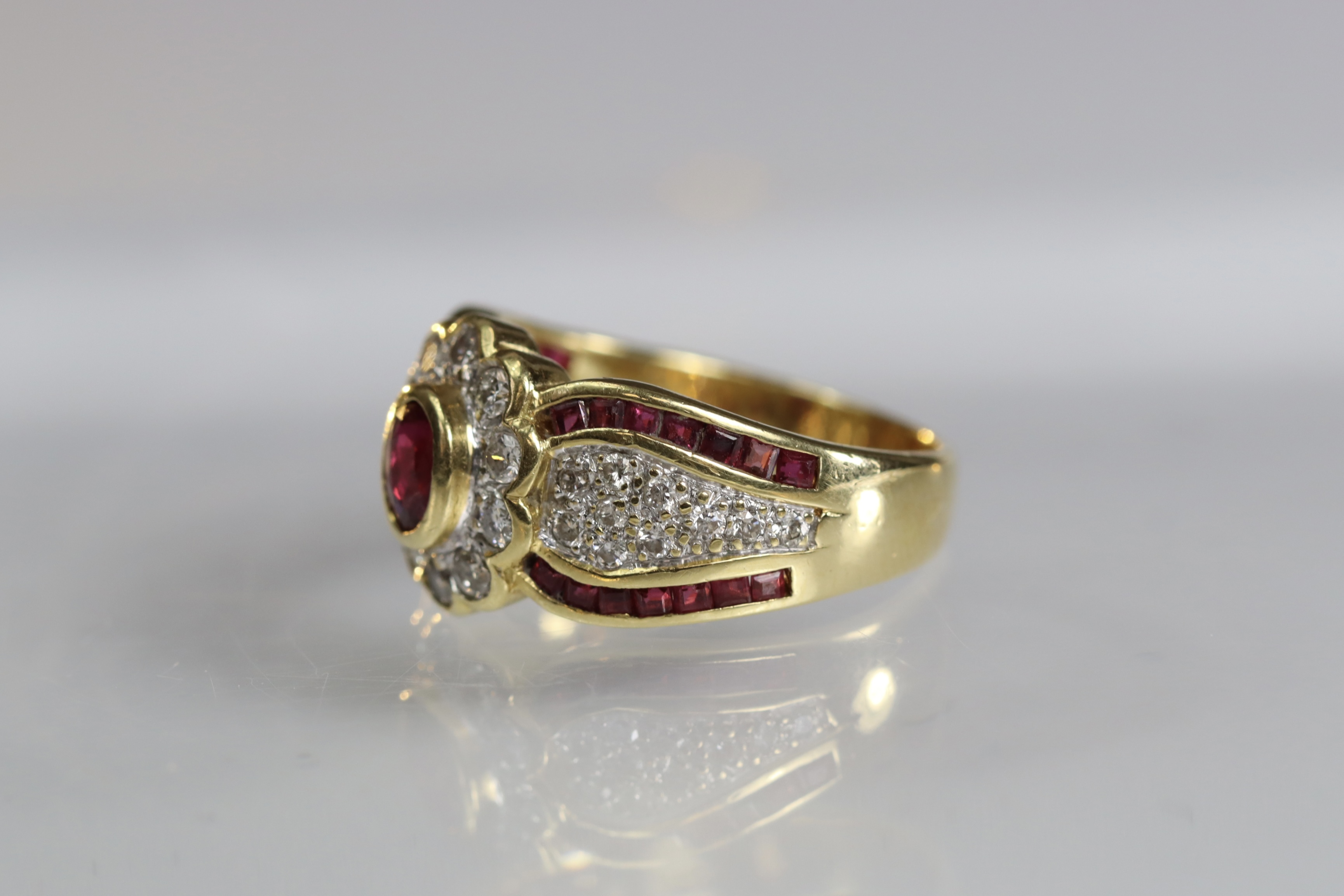 A contemporary 18 carat Yellow Gold, Ruby and Diamond Dress Ring,the oval shaped ruby central - Image 11 of 14