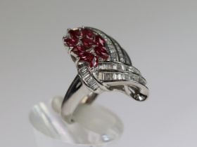 An unusual Ruby and Diamond Dress Ring,mounted in platinum set with nine pear shaped rubies within a