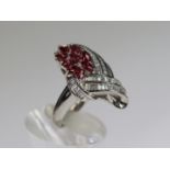 An unusual Ruby and Diamond Dress Ring,mounted in platinum set with nine pear shaped rubies within a