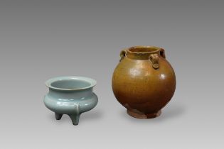 A Longquan Celadon Tripod Censer, Song dynasty or later, and an Amber glazed Jar, Tang dynastyA