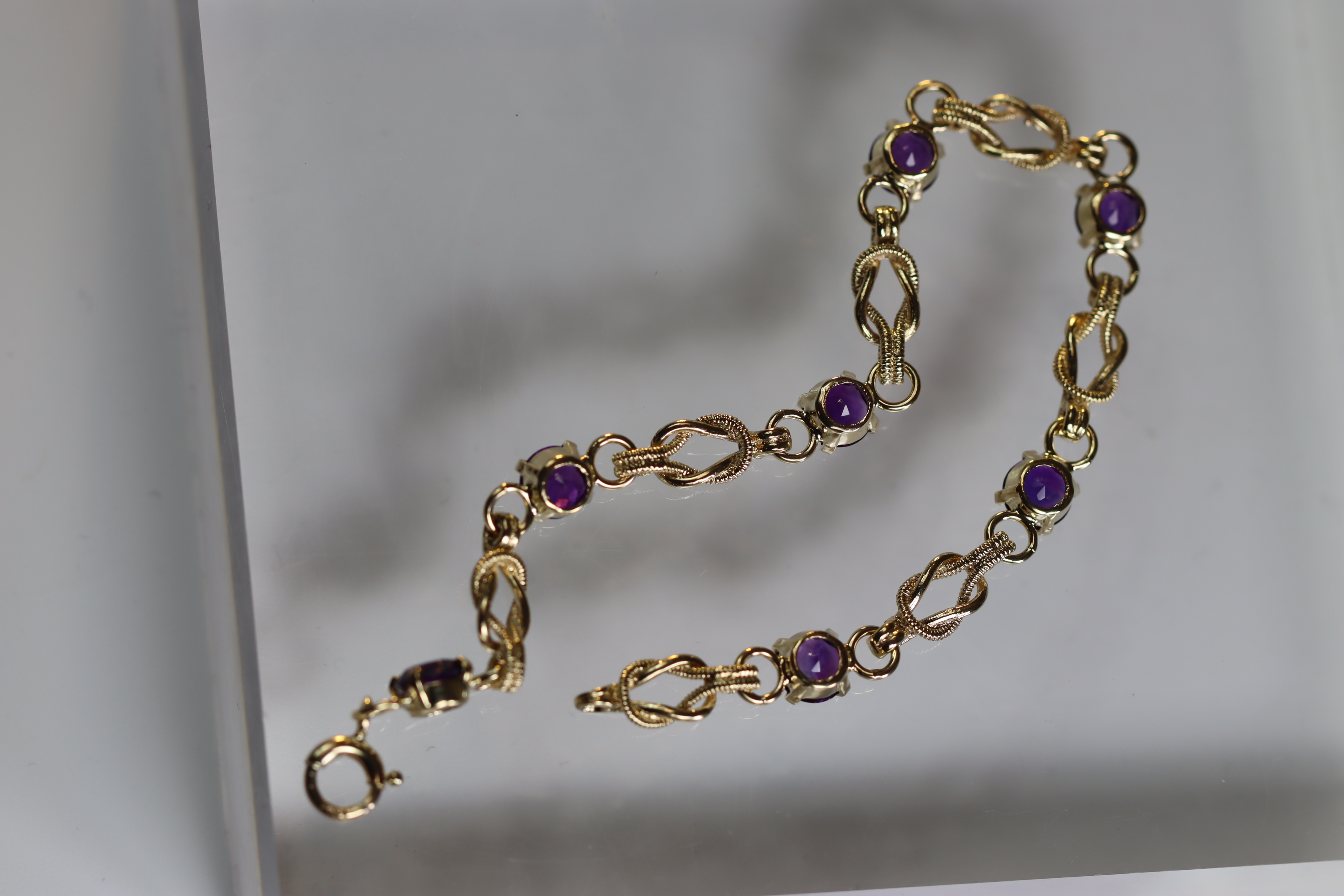 An Amethyst and 9 Carat Yellow Gold Line Bracelet set with seven circular mixed cut amethysts, - Image 4 of 8