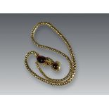 An attractive Antique Cabochon Garnet and Yellow Gold Snake Pendant, circa 1870,the head formed from