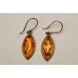 A Pair of Navette shaped Amber and Yellow Metal Pendant Earrings A Pair of Navette shaped Amber