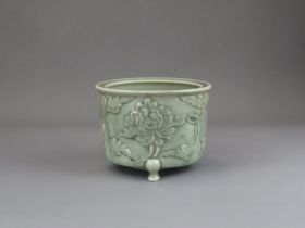 A Longquan Celadon Peony Tripod Censer, early Ming dynasty,