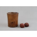 A Pair of carved Walnuts and a Wood Brushpot, 19/20th Century