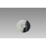 A Black and White Jade Dragon and Phoenix Bi Disc, Ming dynasty or earlier