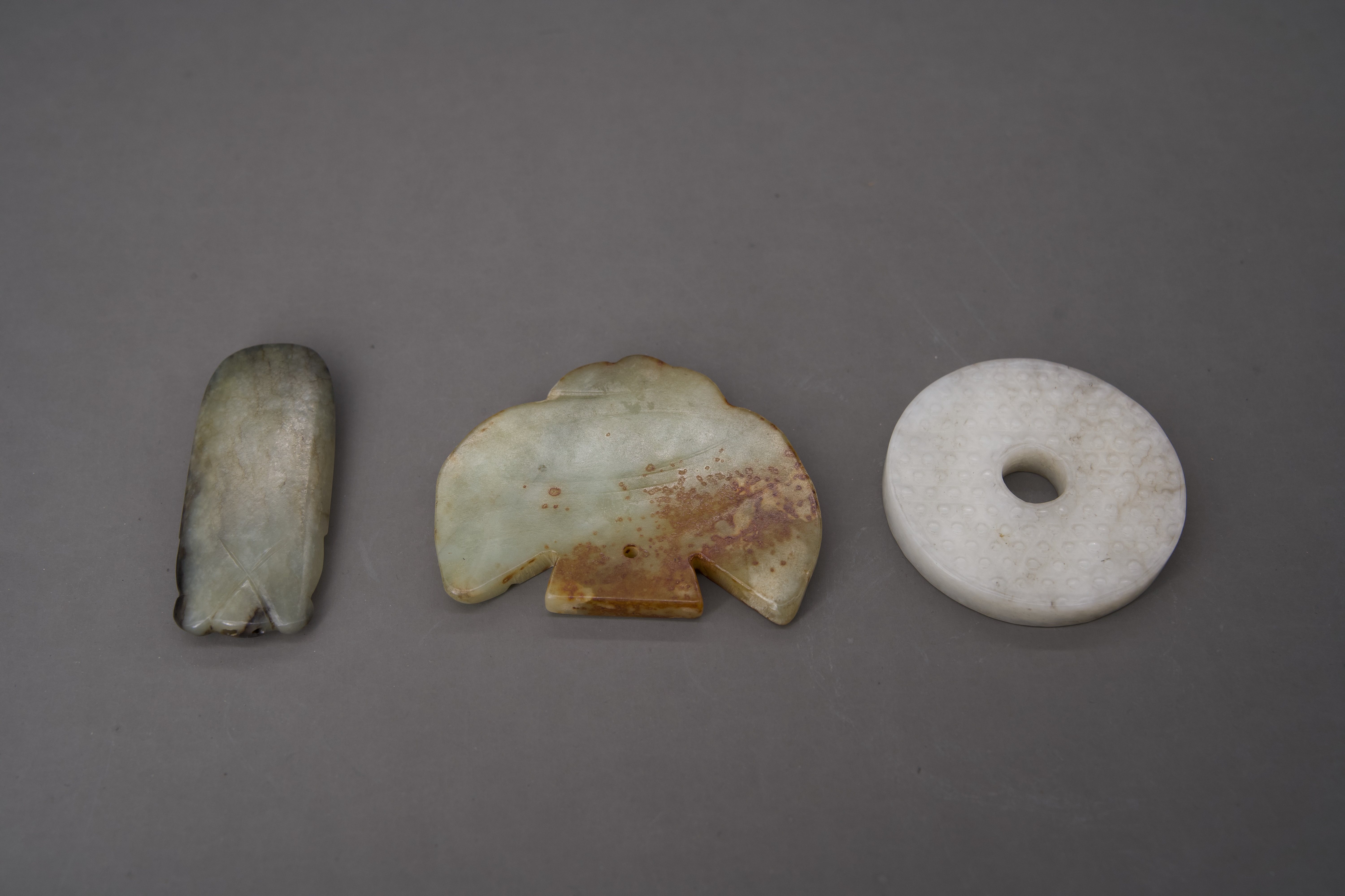 A Miniature Jade Bi Disc, 18th century, and two archaistic jades - Image 3 of 4