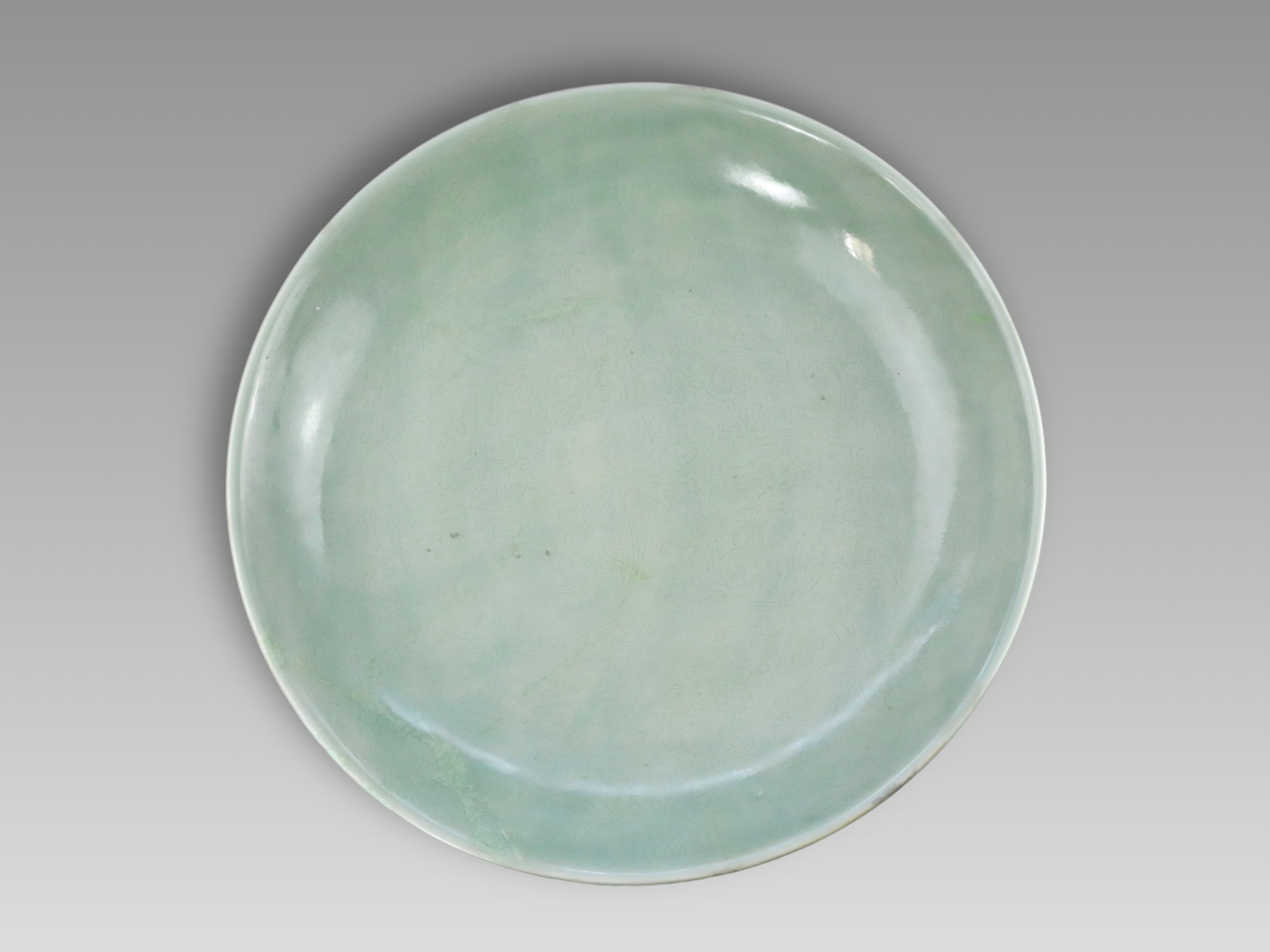 A Rare Celadon Large Dish carved with Lotus, six character underglaze blue mark of Kangxi