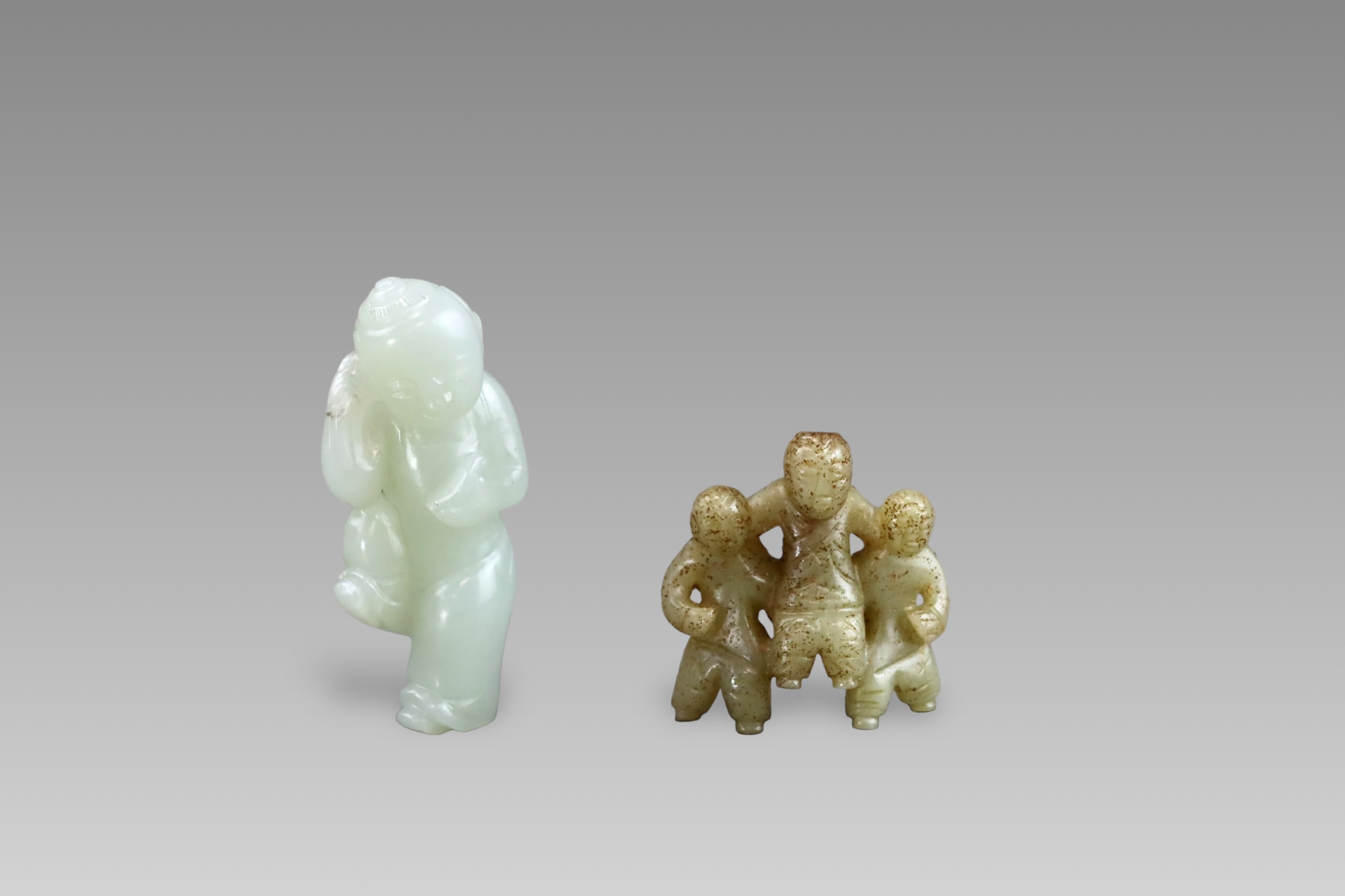 A Pale Celadon Jade Boy, and a Brown Jade Three Boy Group, Qianlong and earlier,