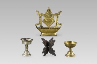 A Gilt Copper Altar Emblem, 17/18th century, Two Butter Lamps and a Stand, 19/20th century,
