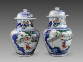 A Good Pair of Wucai Jars and Covers with Figures, 19th century,
