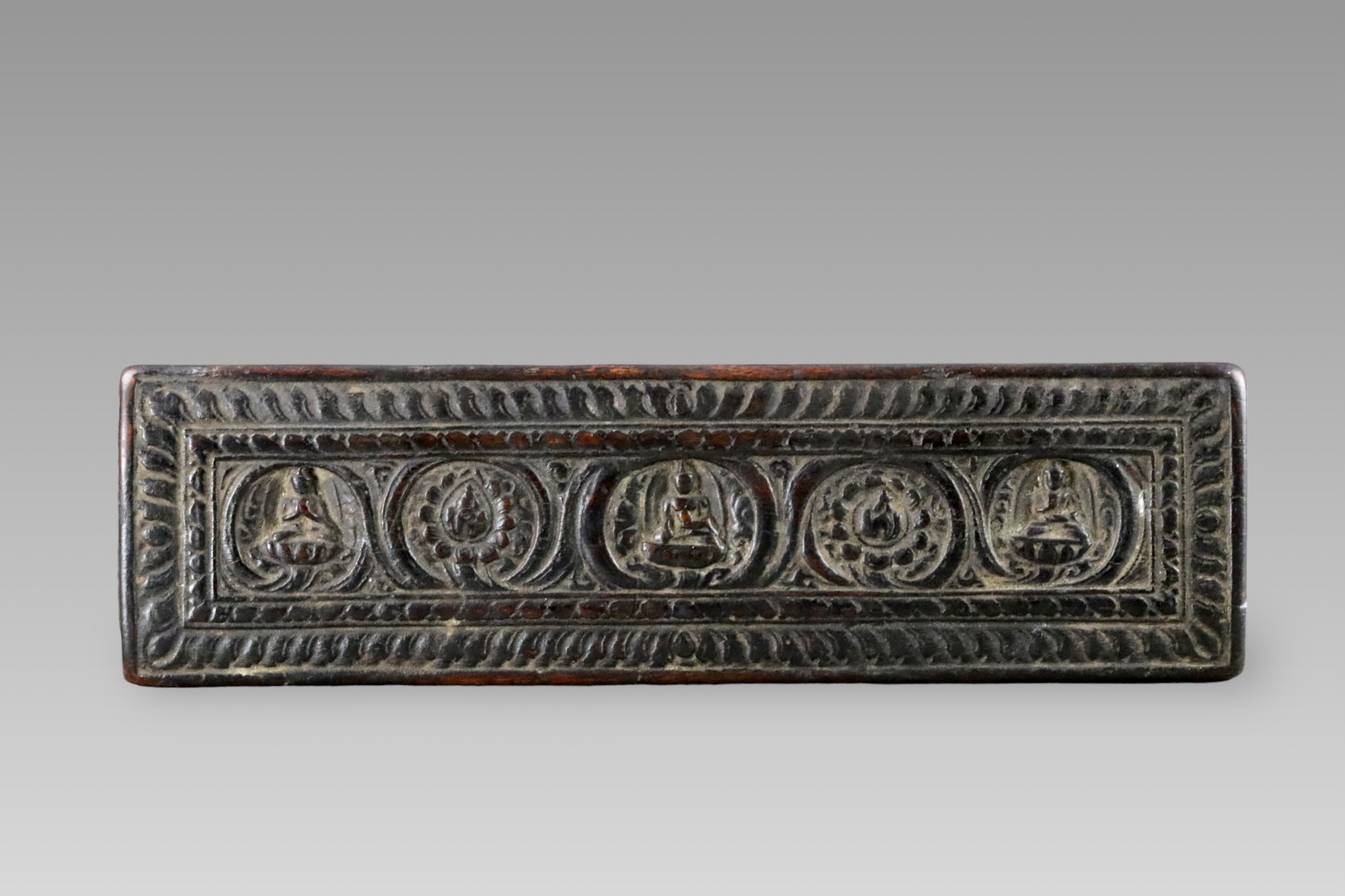 A Blackwood Book Cover carved with Buddhas, 15th century