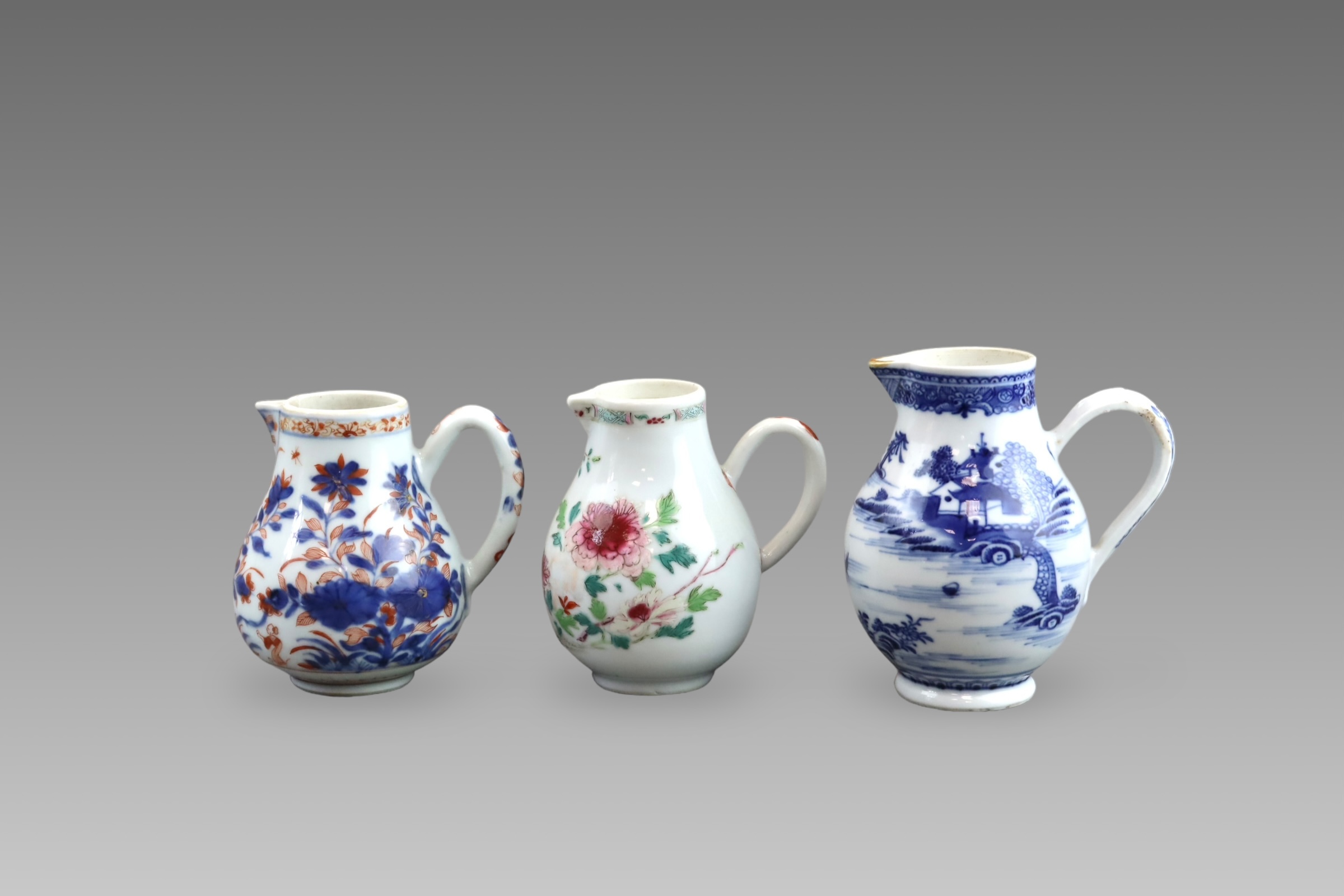 Three Blue and White and 'famille rose' Milk Jugs, 18th century