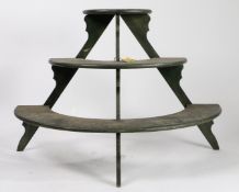 A DEMI-LUNE THREE TIER PLANT STAND.