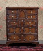 A GEORGE III OAK EAST ANGLIAN GEOMETRIC CHEST OF DRAWERS.