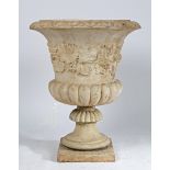 A RECONSTITUTED STONE GARDEN URN.