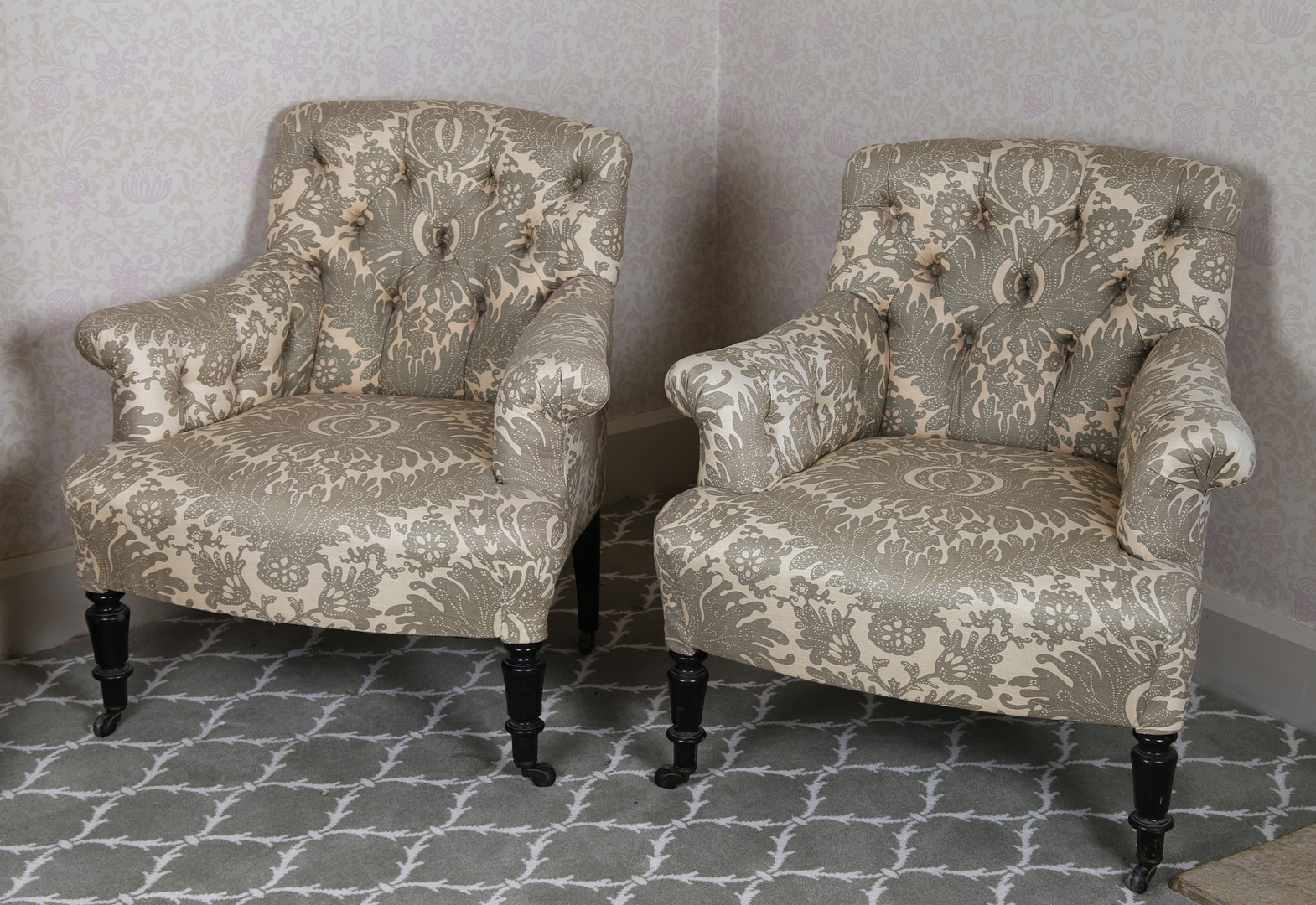 A PAIR OF LATE VICTORIAN LOW ARMCHAIRS.