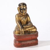 A CARVED AND GILT WOOD BUDDHA.